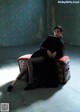 A woman sitting on top of a red chair.