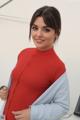 A woman in a red and blue shirt posing for a picture.